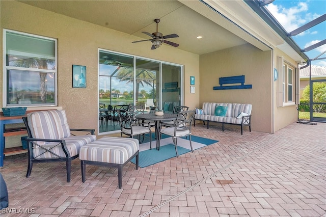 view of patio / terrace featuring a lanai, ceiling fan, and an outdoor hangout area