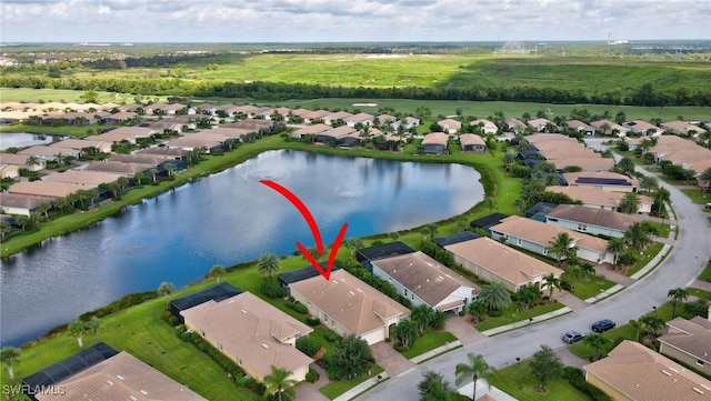 birds eye view of property with a water view