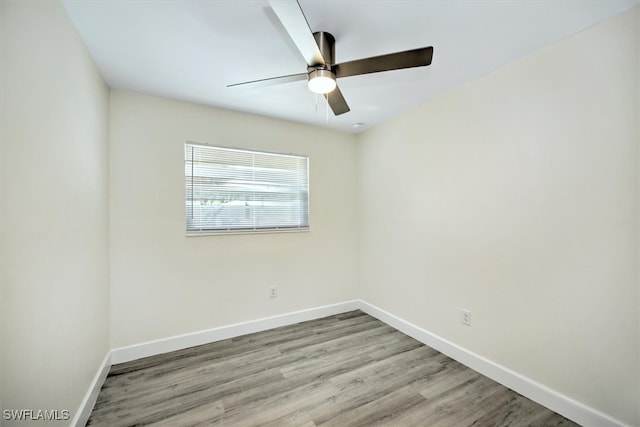 empty room featuring ceiling fan and hardwood / wood-style flooring