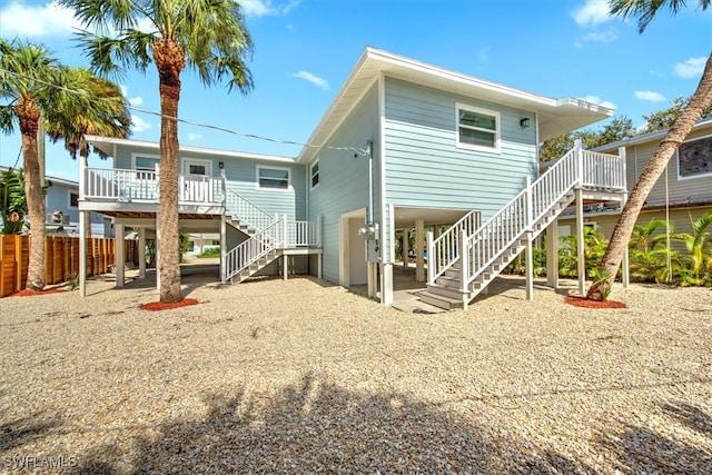 rear view of property with covered porch