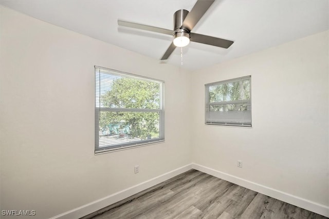 empty room featuring light wood-style flooring, baseboards, and ceiling fan