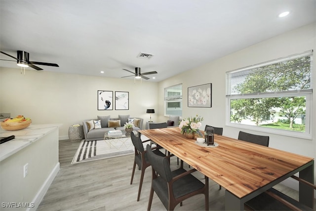 dining area featuring light wood-type flooring and ceiling fan