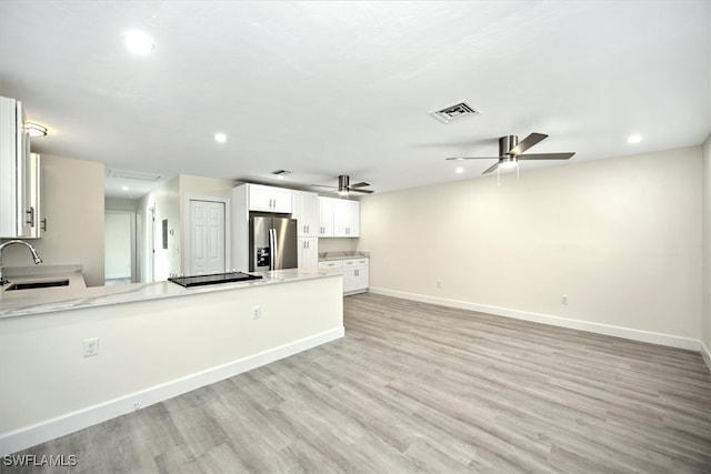 kitchen featuring stainless steel fridge, light hardwood / wood-style floors, sink, white cabinetry, and ceiling fan