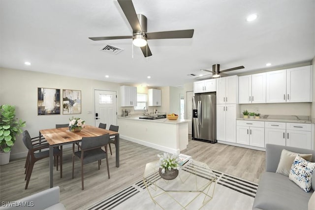 living room with a ceiling fan, baseboards, visible vents, recessed lighting, and light wood-type flooring