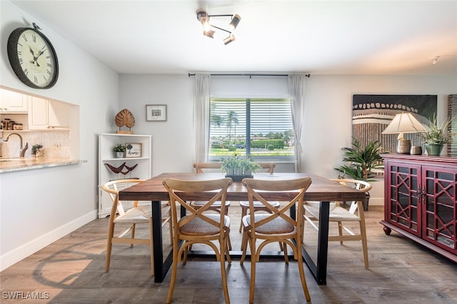 dining area featuring baseboards and wood finished floors