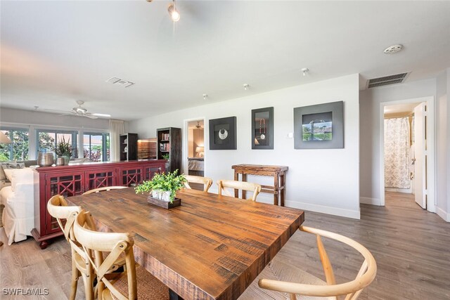 dining space featuring baseboards, visible vents, and light wood-type flooring