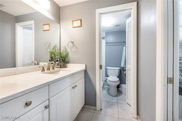 bathroom with vanity, toilet, and tile patterned floors