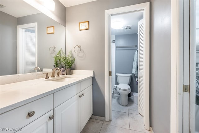 bathroom featuring tile patterned flooring, vanity, toilet, and visible vents