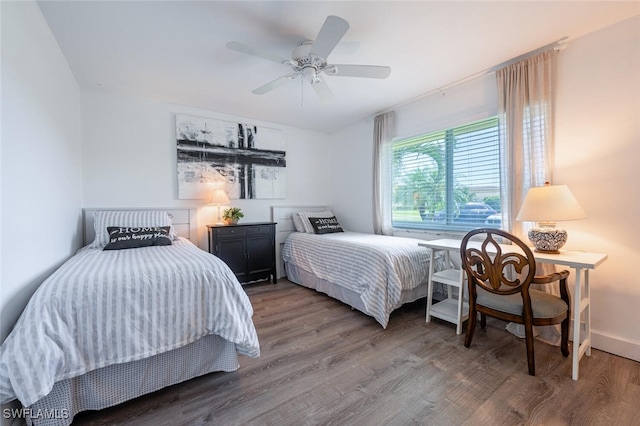 bedroom with baseboards, ceiling fan, and wood finished floors