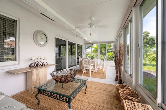 sunroom featuring tile patterned floors and a textured wall