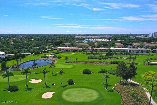 birds eye view of property with golf course view and a water view