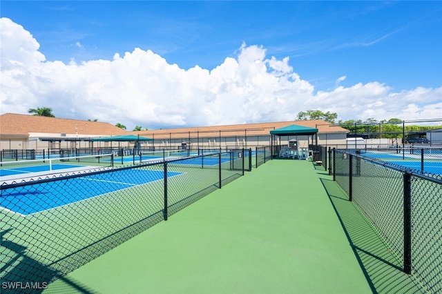 view of tennis court featuring fence
