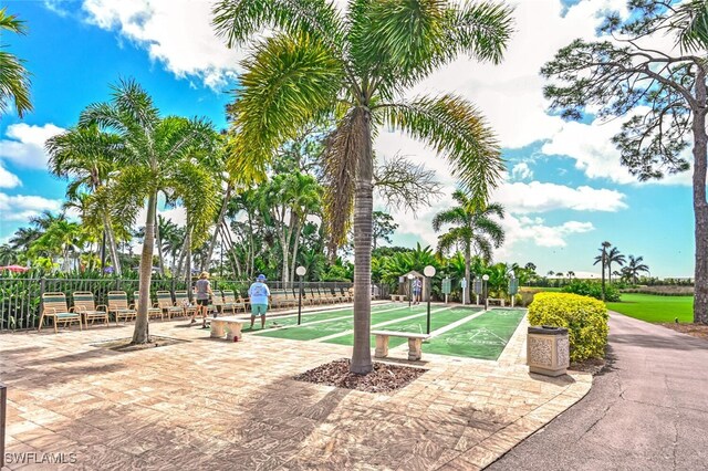 surrounding community with fence and shuffleboard