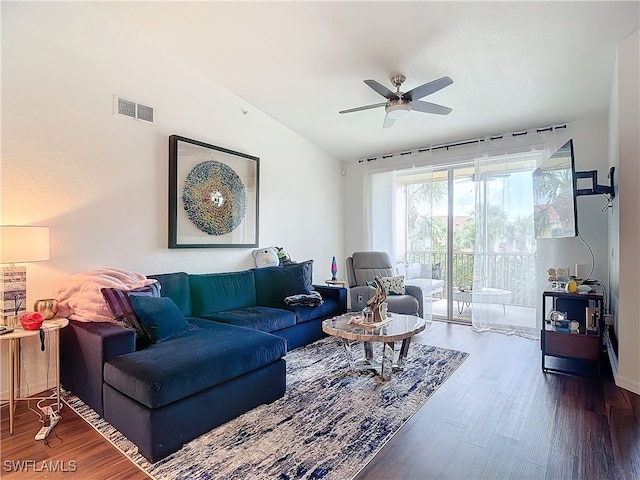 living room featuring vaulted ceiling, ceiling fan, and dark hardwood / wood-style floors