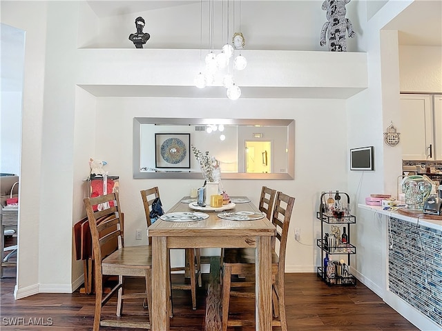 dining room with lofted ceiling and dark wood-type flooring