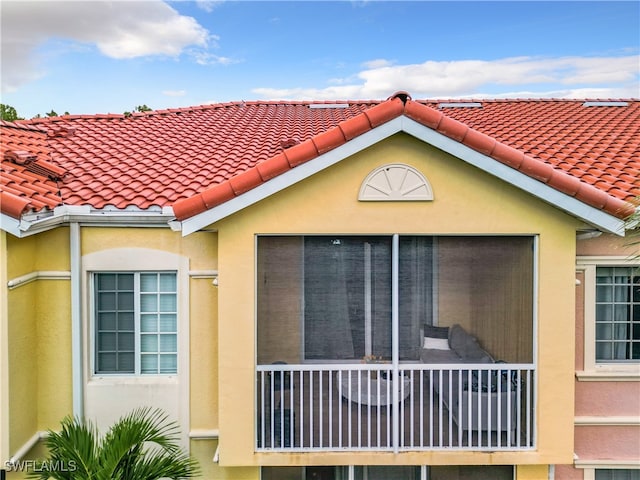 back of property featuring a balcony