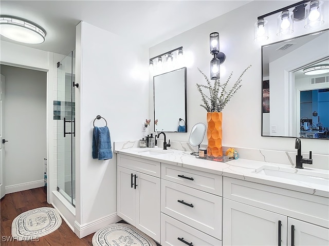 bathroom featuring vanity, hardwood / wood-style floors, and a shower with shower door