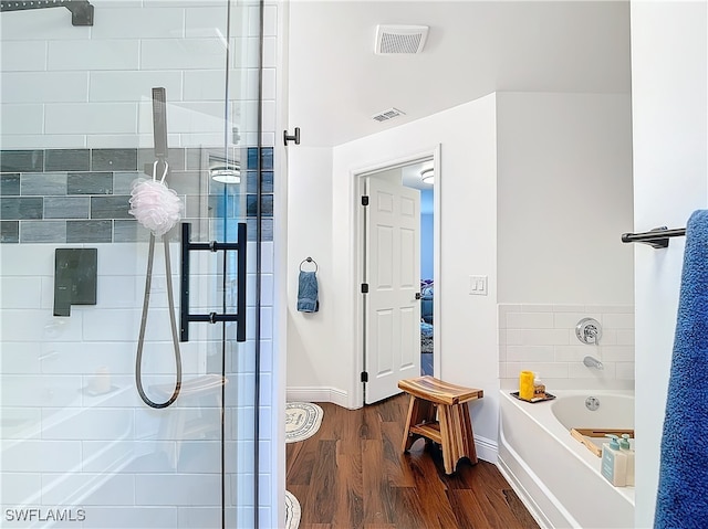 bathroom featuring independent shower and bath and wood-type flooring