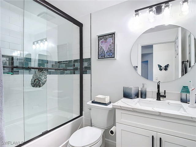 full bathroom with shower / bath combination with glass door, vanity, and toilet