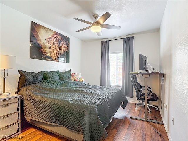 bedroom featuring a textured ceiling, hardwood / wood-style flooring, and ceiling fan