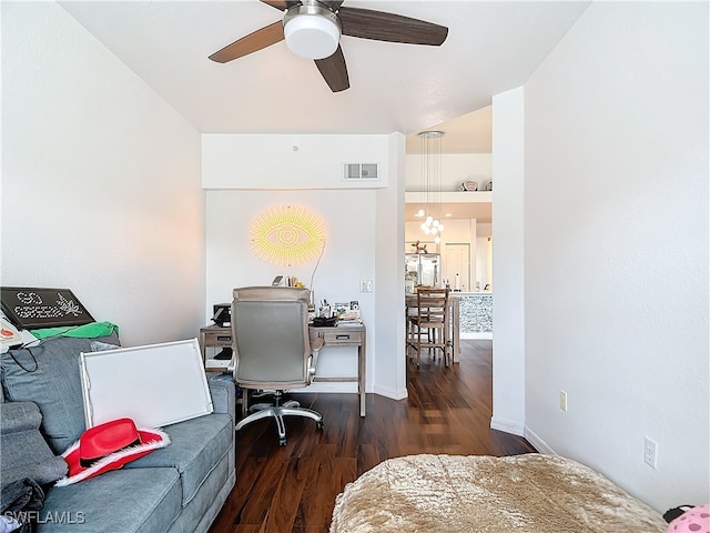 office space featuring ceiling fan with notable chandelier and dark hardwood / wood-style flooring