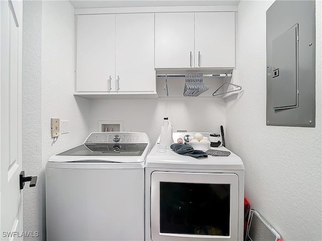 clothes washing area featuring cabinets, electric panel, and independent washer and dryer