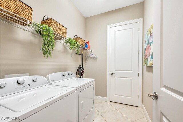 laundry area featuring light tile patterned flooring and independent washer and dryer