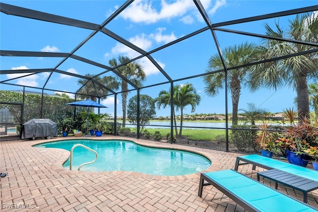 view of pool with a grill, a lanai, a patio area, and a water view