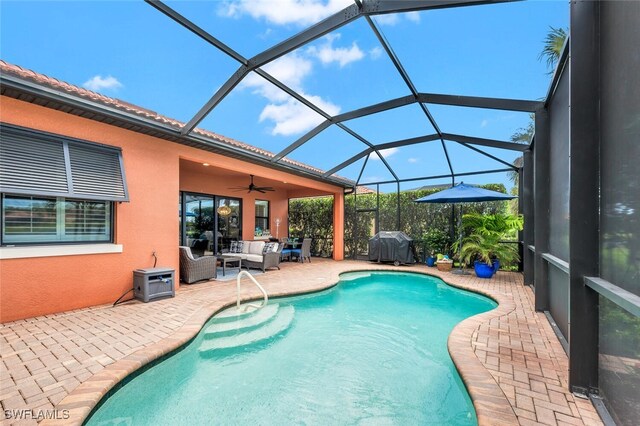 view of swimming pool with outdoor lounge area, a grill, a lanai, ceiling fan, and a patio area