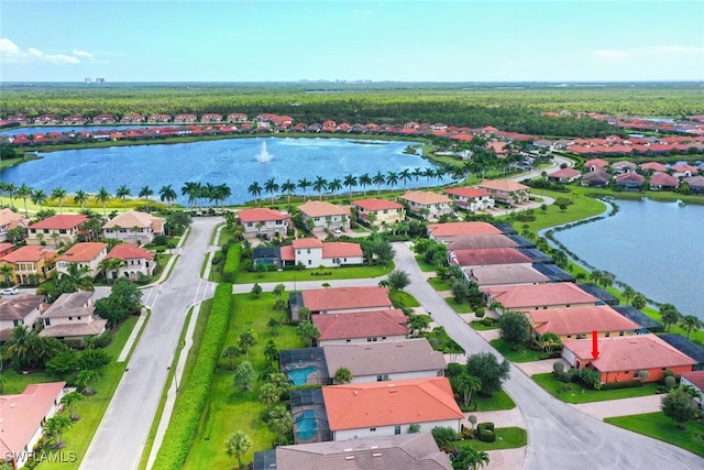 birds eye view of property with a water view