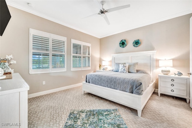 carpeted bedroom with ornamental molding and ceiling fan