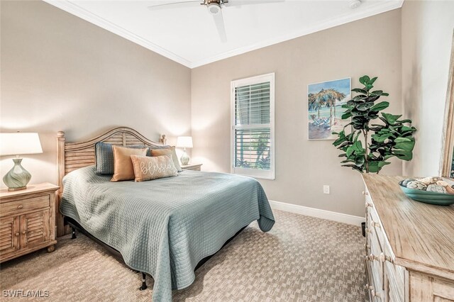 carpeted bedroom with ornamental molding and ceiling fan