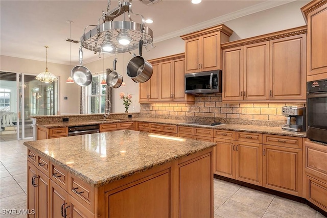 kitchen with a center island, sink, hanging light fixtures, crown molding, and appliances with stainless steel finishes