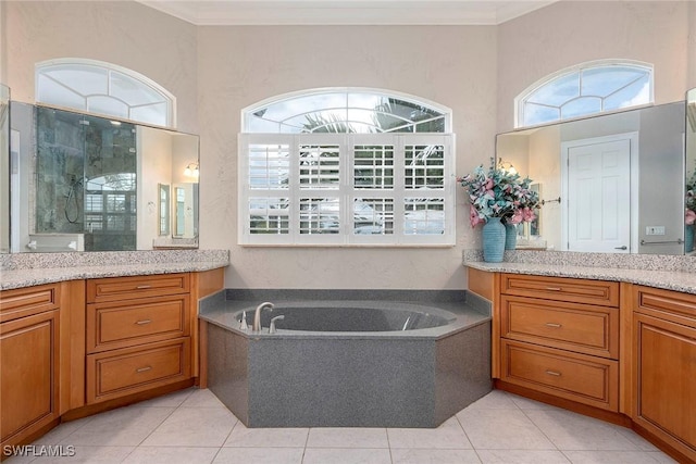 bathroom with plus walk in shower, vanity, and tile patterned floors