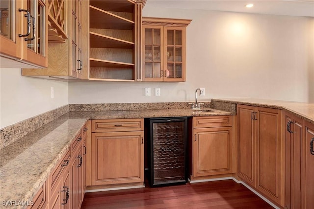 kitchen featuring sink, light stone countertops, dark wood-type flooring, and wine cooler