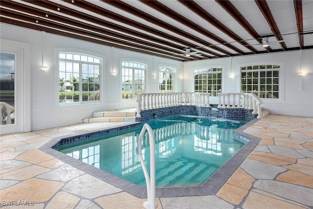 view of swimming pool with a jacuzzi and pool water feature