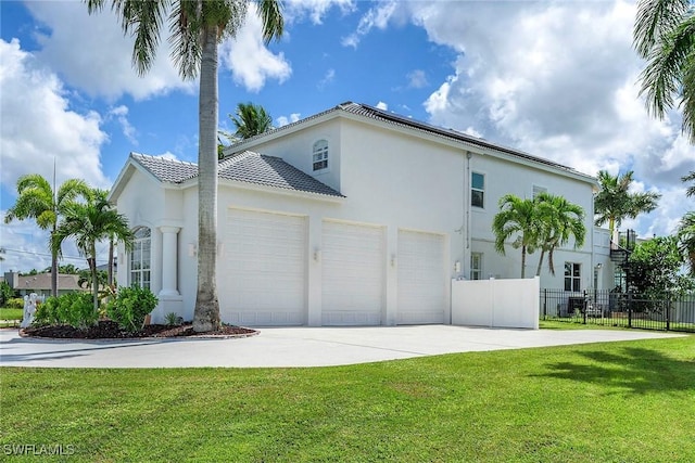 view of side of property with a yard and a garage