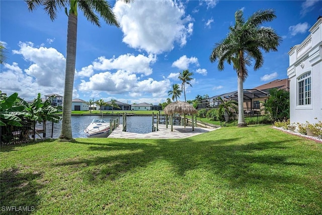 dock area with a water view and a yard