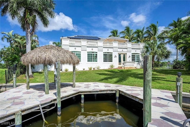 view of dock featuring a yard, a balcony, and a water view