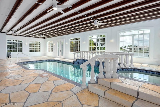 indoor pool featuring ceiling fan and a hot tub