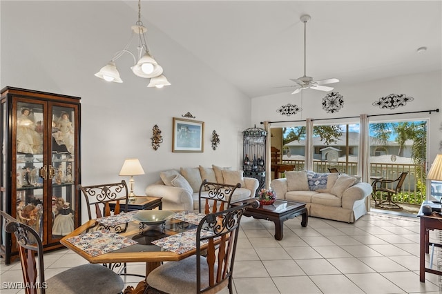 tiled dining space featuring ceiling fan and vaulted ceiling