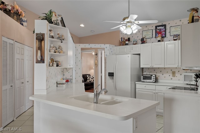 kitchen with white appliances, white cabinetry, sink, lofted ceiling, and ceiling fan