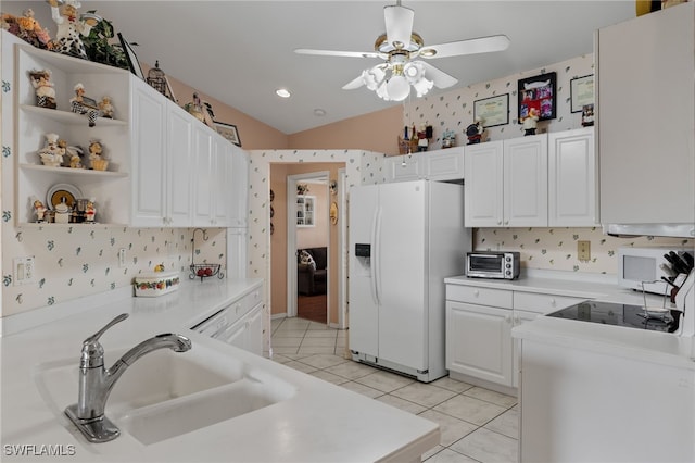 kitchen featuring white cabinets, light tile patterned floors, white refrigerator with ice dispenser, sink, and ceiling fan