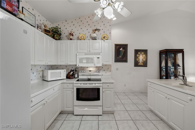 kitchen featuring white cabinetry, vaulted ceiling, white appliances, and ceiling fan