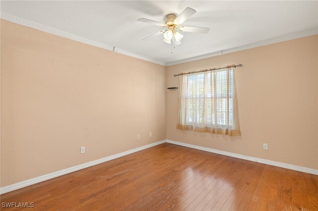 1010 Partridge Cir Unit 202, Naples, FL 34104 - empty room featuring hardwood / wood-style flooring, a ceiling fan, baseboards, and crown molding