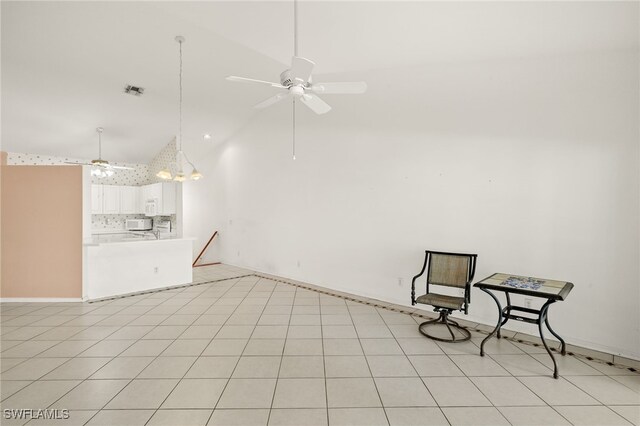 1010 Partridge Cir Unit 202, Naples, FL 34104 - unfurnished living room with ceiling fan and high vaulted ceiling