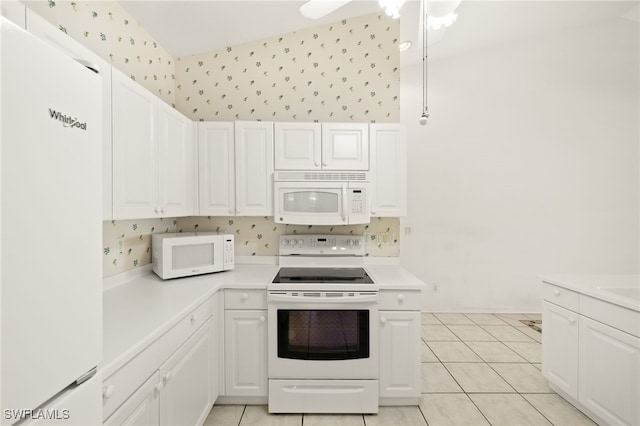 1010 Partridge Cir Unit 202, Naples, FL 34104 - kitchen featuring white appliances, light countertops, wallpapered walls, and white cabinetry