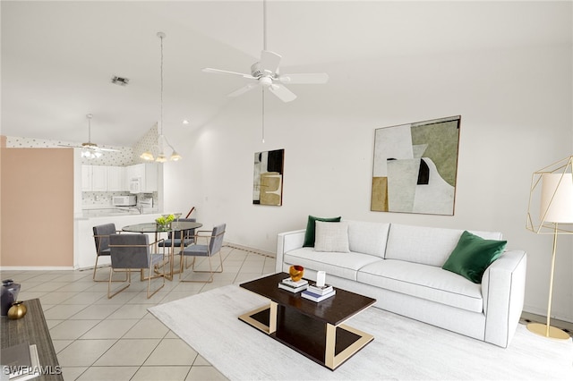 1010 Partridge Cir Unit 202, Naples, FL 34104 - living area featuring a ceiling fan, light tile patterned floors, baseboards, and high vaulted ceiling