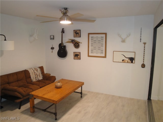 living room with ceiling fan and light hardwood / wood-style floors