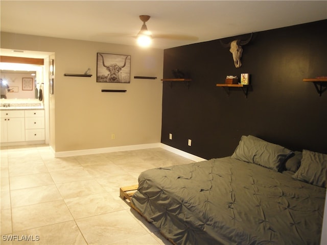 bedroom featuring connected bathroom, light tile patterned floors, and ceiling fan